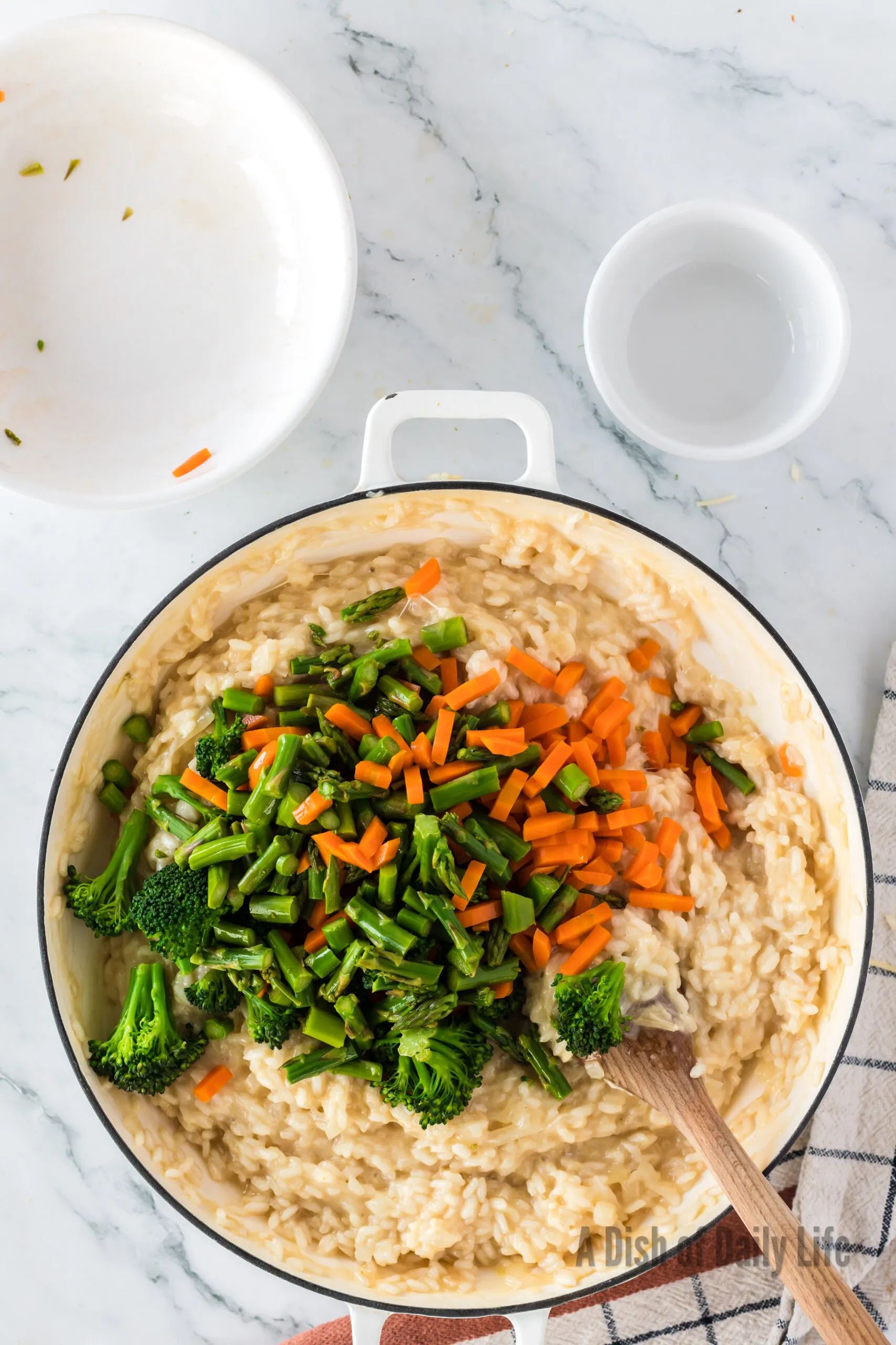 Cooked vegetables added to Risotto