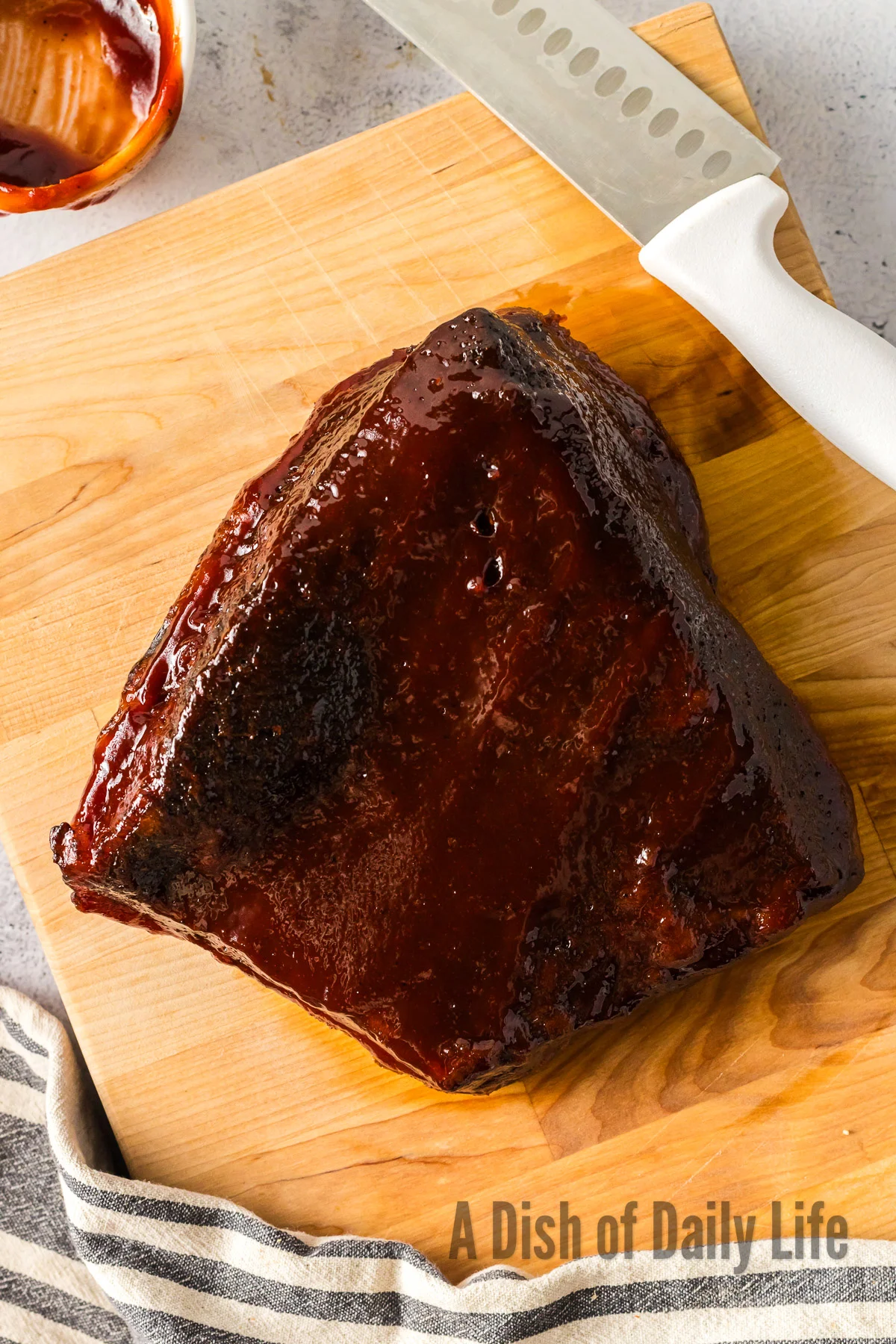 cooked brisket on cutting board, unsliced