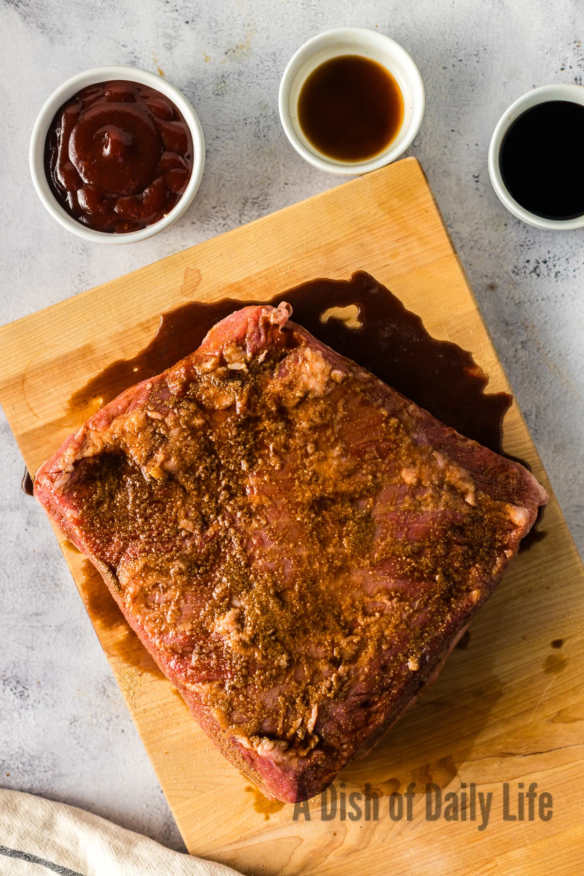 liquid smoke and Worcestershire sauce poured over the seasoned meat.