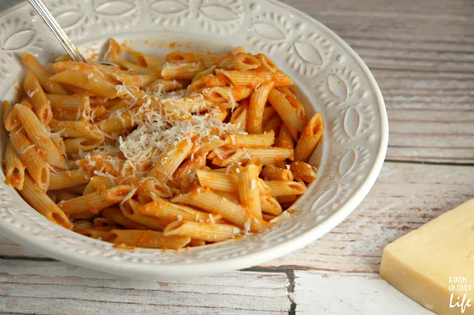 This Lightened Up Pink Vodka Sauce recipe, served over pasta, is a delicious easy meal when you need to get dinner on the table fast! It makes enough sauce for two pounds of pasta, so freeze your leftover sauce for another night. Created for Cooking for a Cure to bring awareness to Breast Cancer Awareness Month. Vegetarian