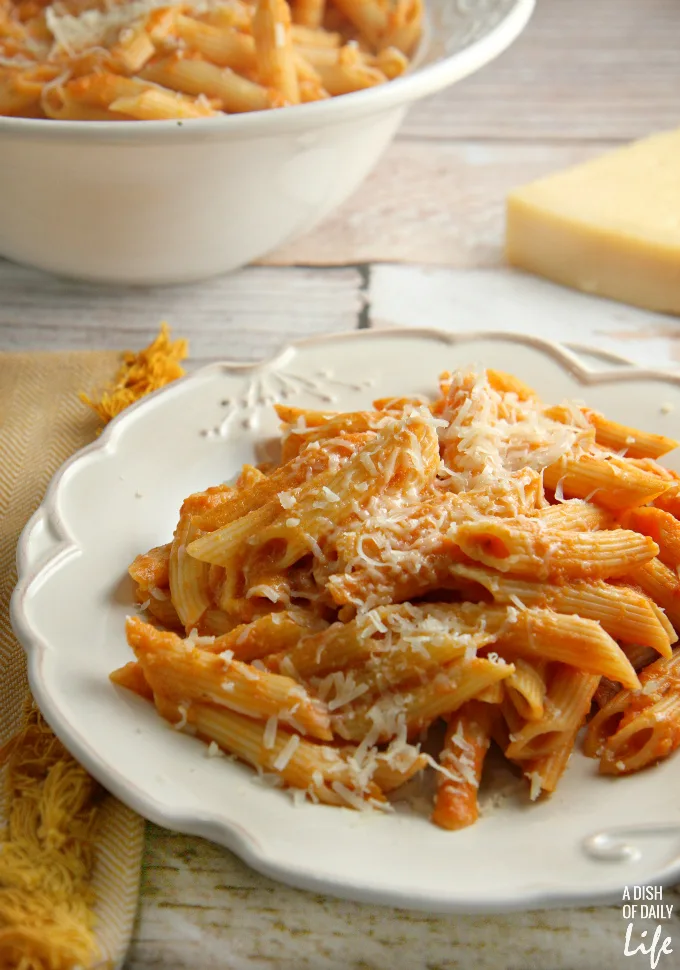 This Lightened Up Pink Vodka Sauce recipe, served over pasta, is a delicious easy meal when you need to get dinner on the table fast! It makes enough sauce for two pounds of pasta, so freeze your leftover sauce for another night. Created for Cooking for a Cure to bring awareness to Breast Cancer Awareness Month. Vegetarian.
