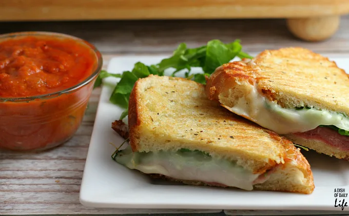 The Italian Panini...a quick and easy gourmet sandwich packed with deliciousness! Stuffed with layers of prosciutto, mozzarella, and arugula, and served with marinara for dipping, this is the perfect dinner recipe when you're short on time. (10 min to make!) 