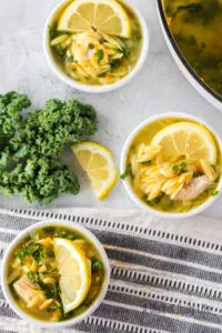 3 bowls of lemon chicken orzo soup ready to serve