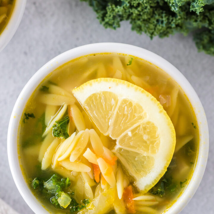 Zoomed in image of bowl of lemon chicken orzo soup