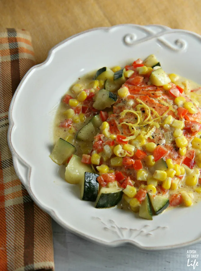 This delicious salmon recipe, finished with a zucchini and corn cream sauce, is easy enough for a weeknight dinner and elegant enough for a special occasion! 30 minute meal.