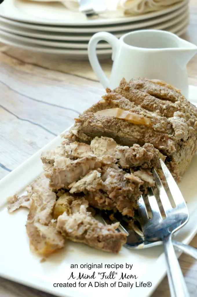 This Slow Cooker Pork Roast with Apples and Mustard is coated in a savory dry rub and stuffed with apples, then braised all day in the slow cooker with a tangy and sharp mustard and cider sauce.