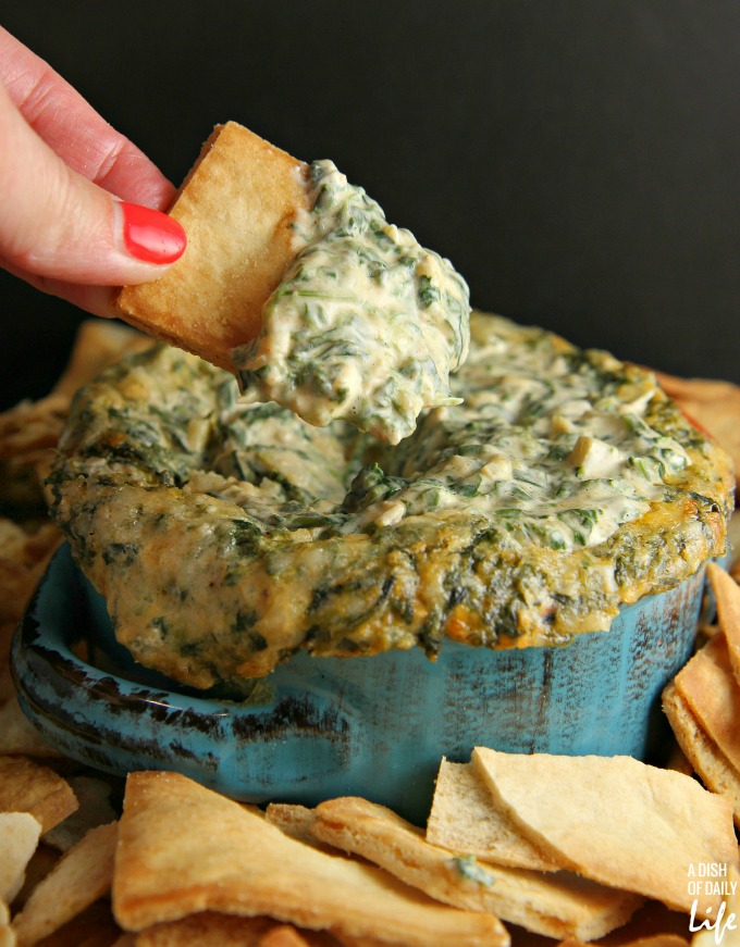 Oooey gooey Spinach and Artichoke dip...perfect for game day or a holiday party! Your guests will never guess how easy it was to make!
