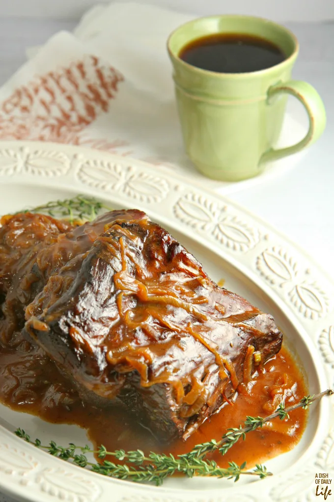 Slow cooked, melt in your mouth Pot Roast with Coffee Gravy and caramelized onions is the perfect comfort food for the chilly winter months!