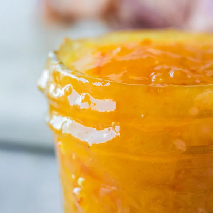 Zoomed in image of orange marmalade glaze in jar