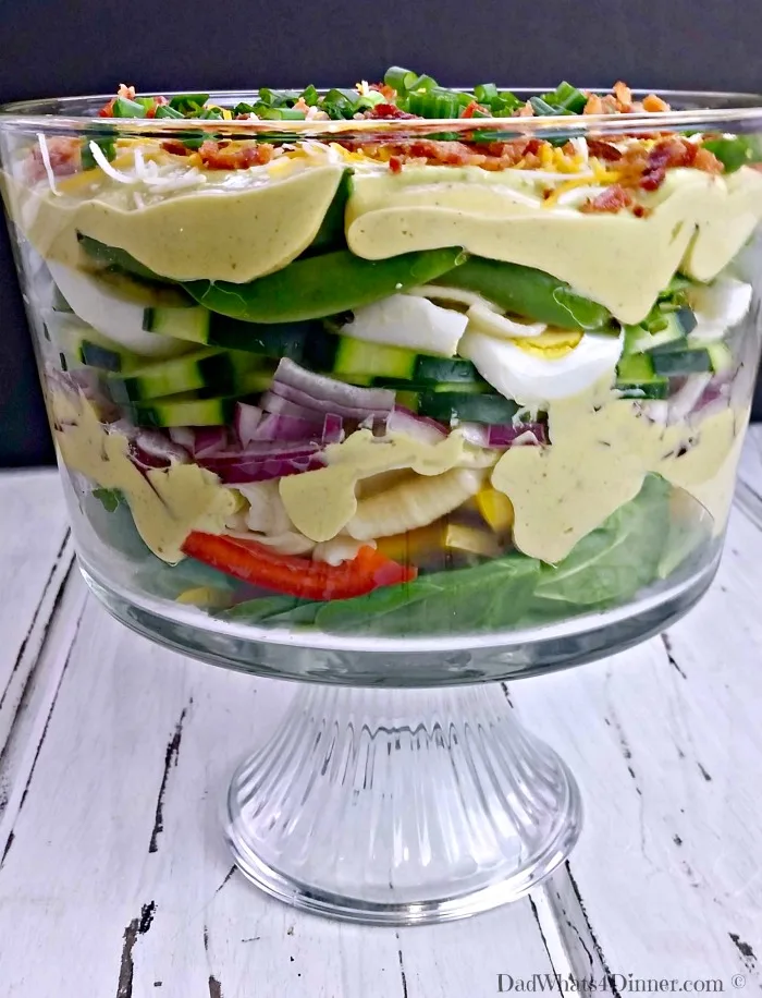 This delicious Creamy Deviled Egg Layered Pasta Salad recipe combines deviled eggs and pasta salad in a dish that is perfect for Easter, Mother's Day, or any potluck get together. The dressing is creamy, egg-y and bold...I think it is the best dressing I have ever made! This is sure to be one of the most popular side dishes at your next get together or holiday dinner!