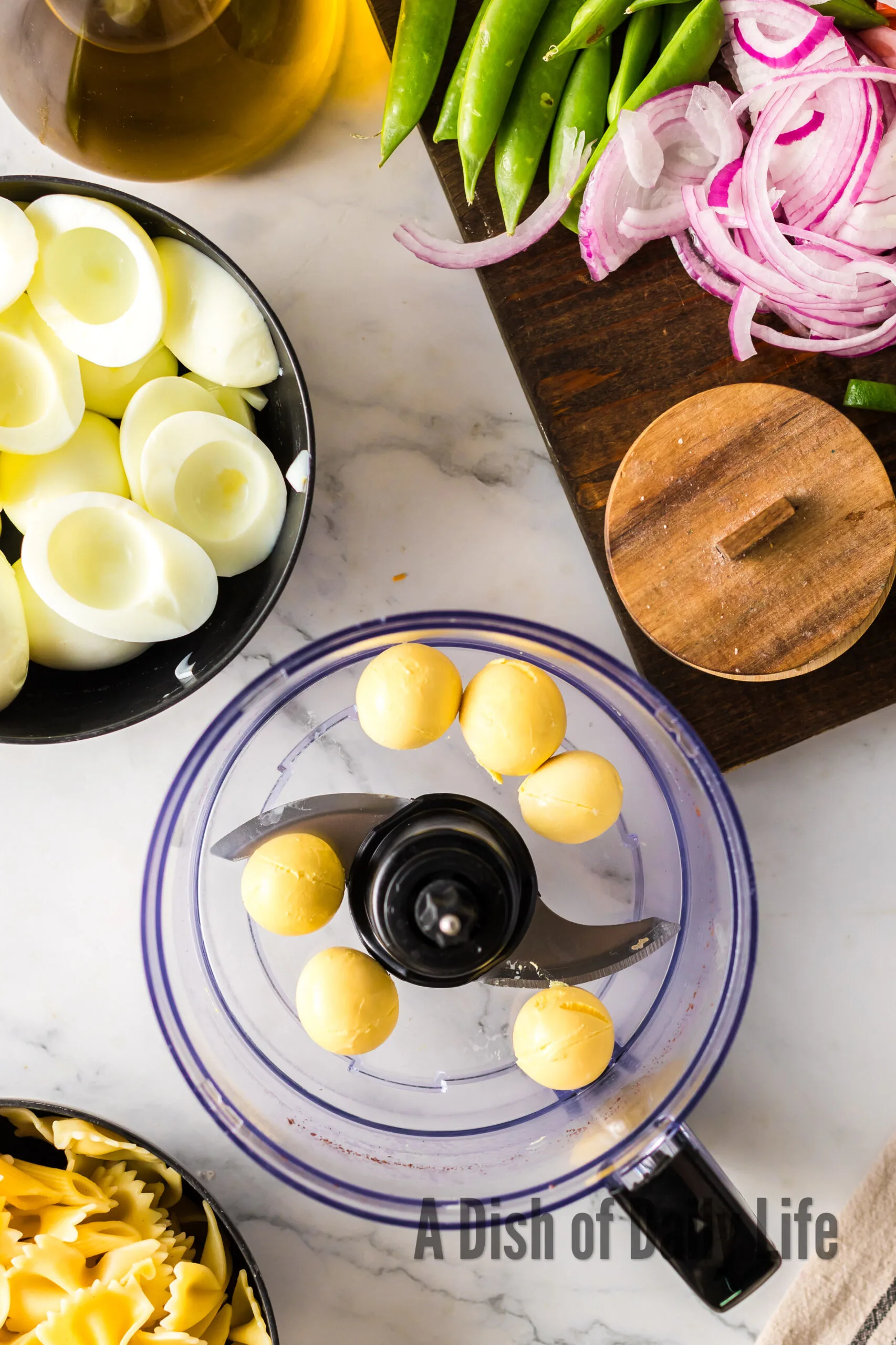 hard boiled eggs are separated with egg yolks in a food processor.