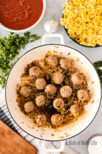 cooked and onions and meatballs in skillet