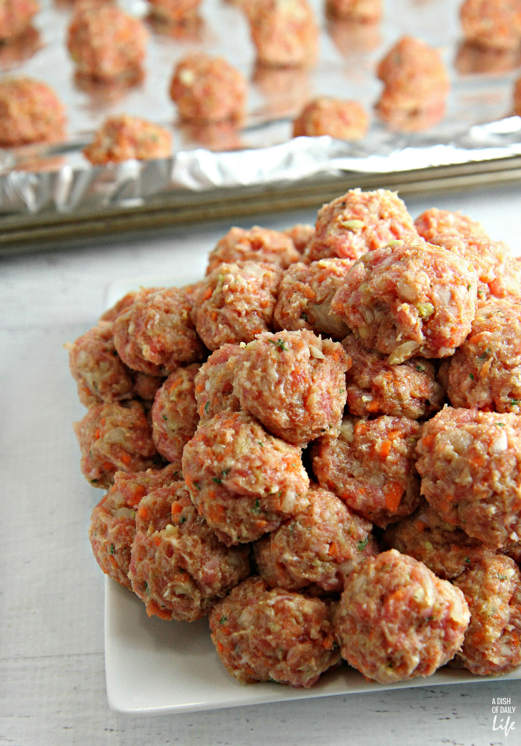 Slow Cooker Pork Meatballs with Orange Sauce...tender, juicy meatballs, packed with vegetables, covered with an orange glaze that everyone goes crazy for! Great as a party appetizer, or delicious easy meal with rice! Leftovers freeze well. 