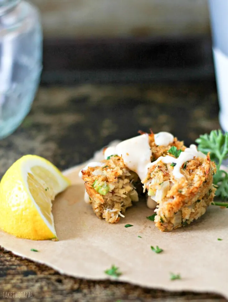 Crab cakes are a great appetizer or main dish for dinner! Muffin Tin Crab Cakes are full of lump crab meat and have the right amount of spice! Drizzle with Old Bay Remoulade for a treat that will take you to the sea! Mini Muffin Tin Crab Cakes with Old Bay Remoulade Recipe | Take Two Tapas