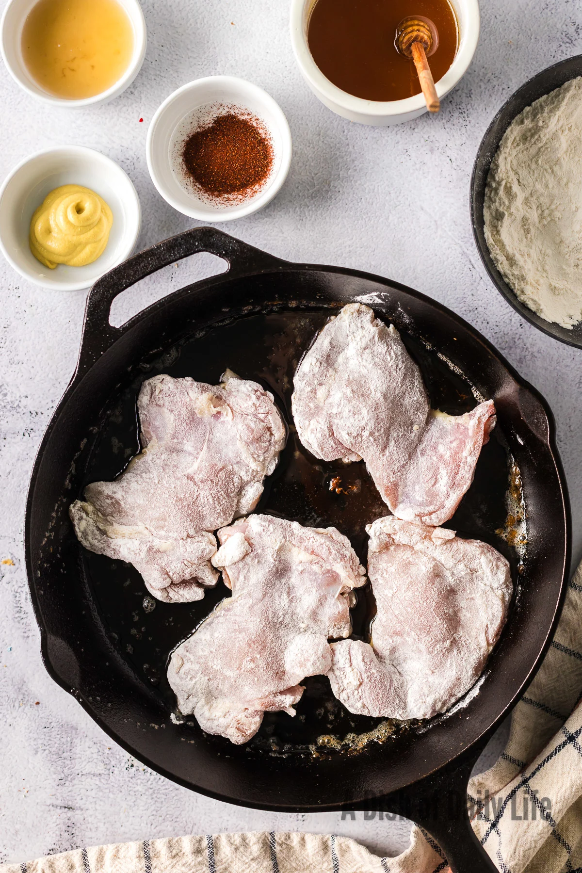 Chicken thighs cooking in bacon grease