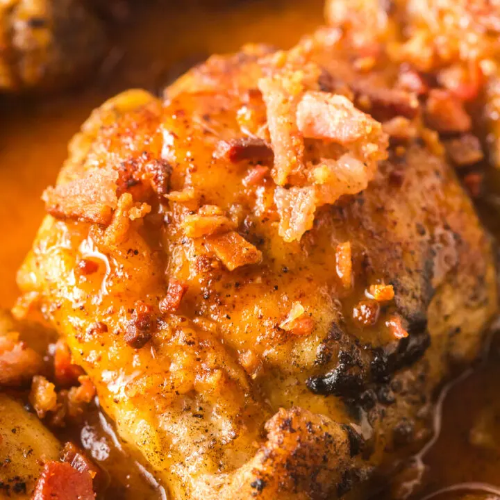 zoomed in image of honey chicken thighs with bacon