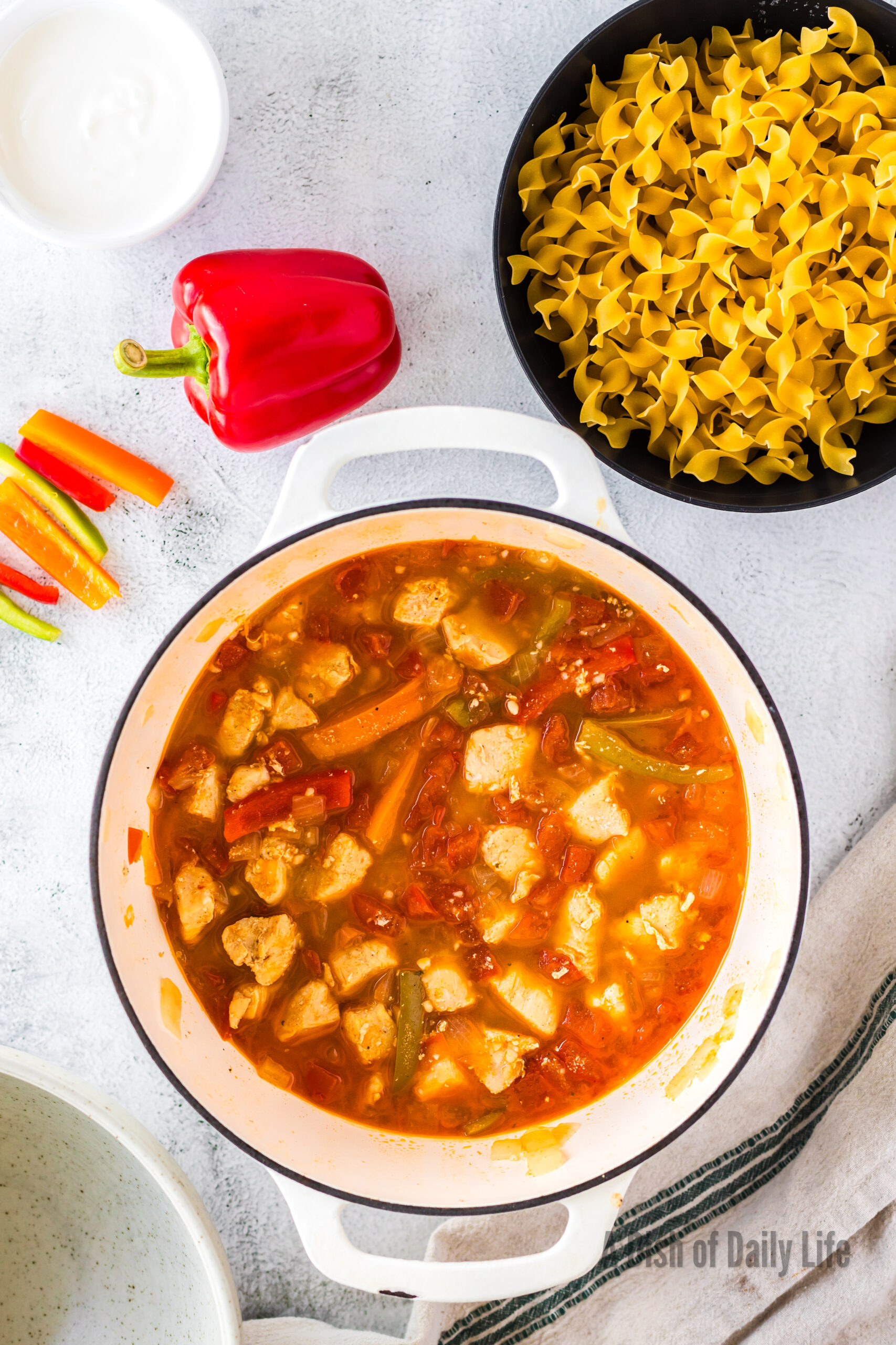 Cooked chicken and vegetables in pot.