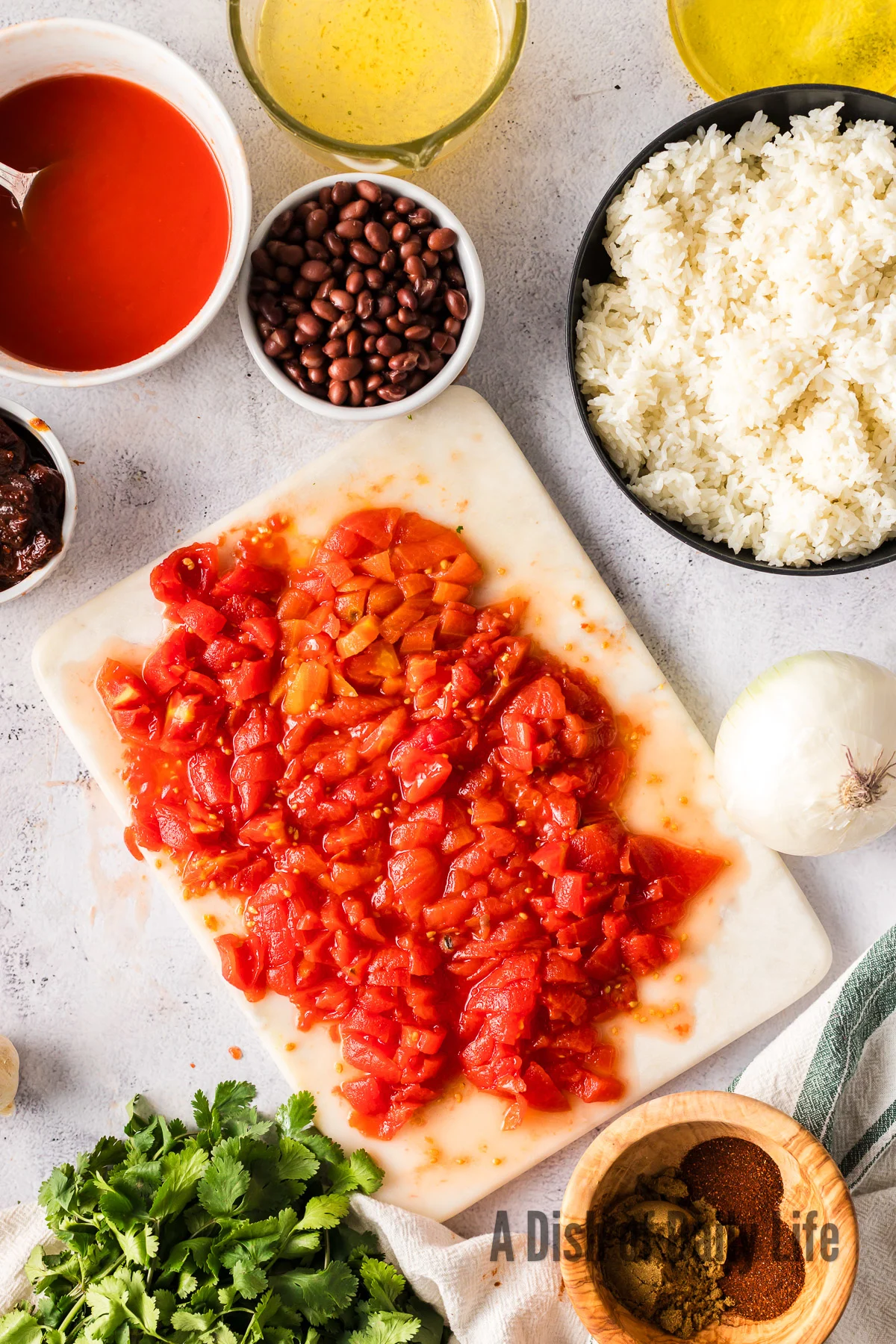 whole tomatoes diced on cutting board.