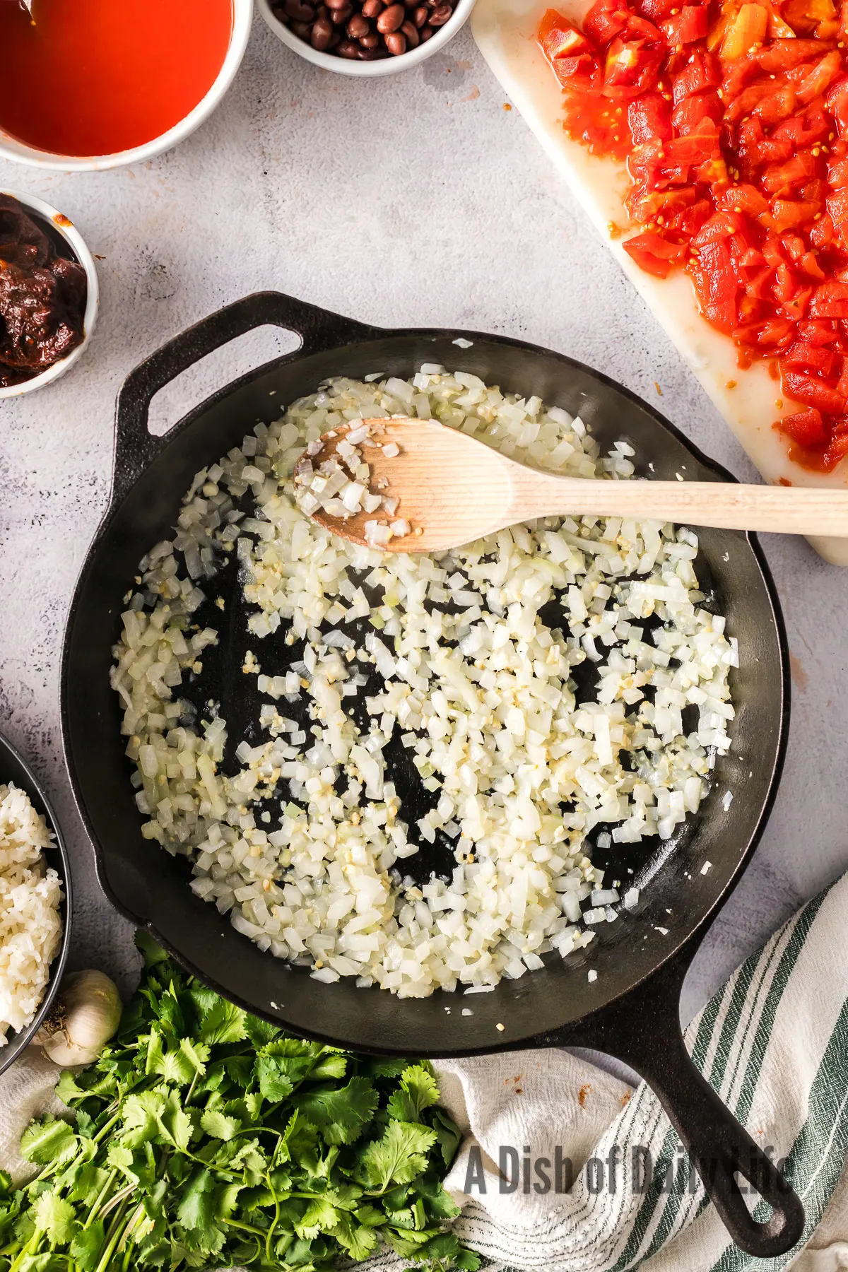 Onions, olive oil and garlic in a skillet being cooked.