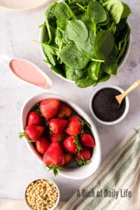 All ingredients laid out on counter for strawberry spinach salad
