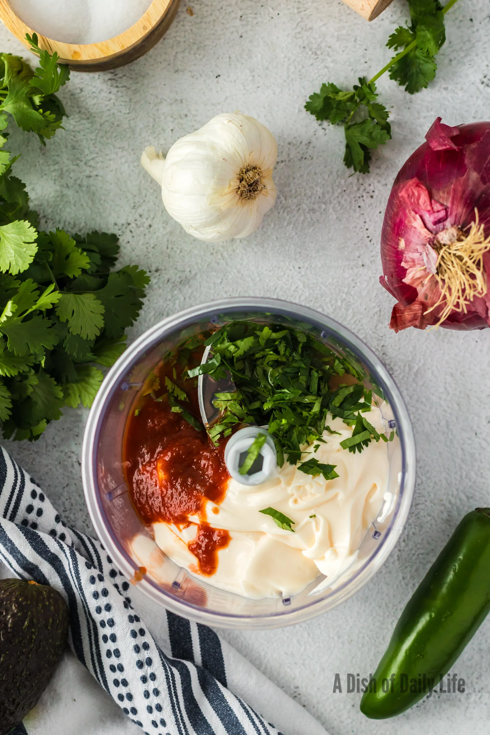 mayonnaise, chipotle, adobo sauce, lime juice and cilantro in a bowl, unmixed.