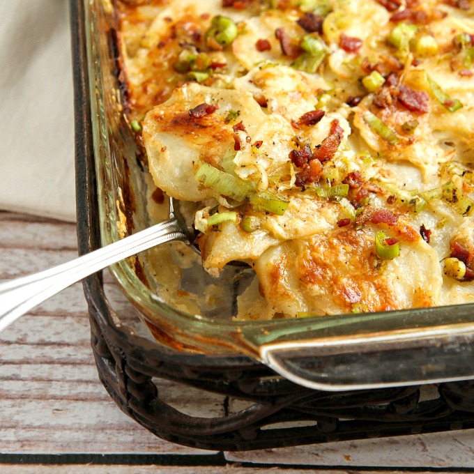 These Cheesy Potatoes with bacon and leeks are packed with creamy goodness, and make a great side dish for any holiday or special occasion dinner! This comfort food casserole is a tried and true family favorite! Family and friends will be begging you for the recipe!