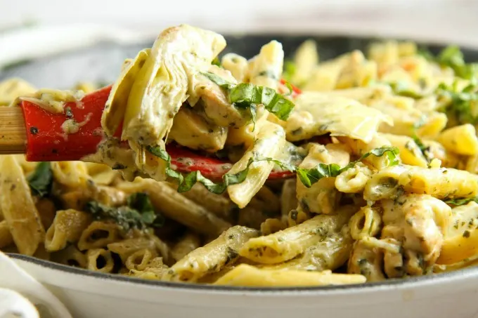 Creamy Chicken Pesto Pasta with Artichokes...an easy comfort food recipe perfect for busy weeknight dinners. You can have it on the table in 30 minutes!