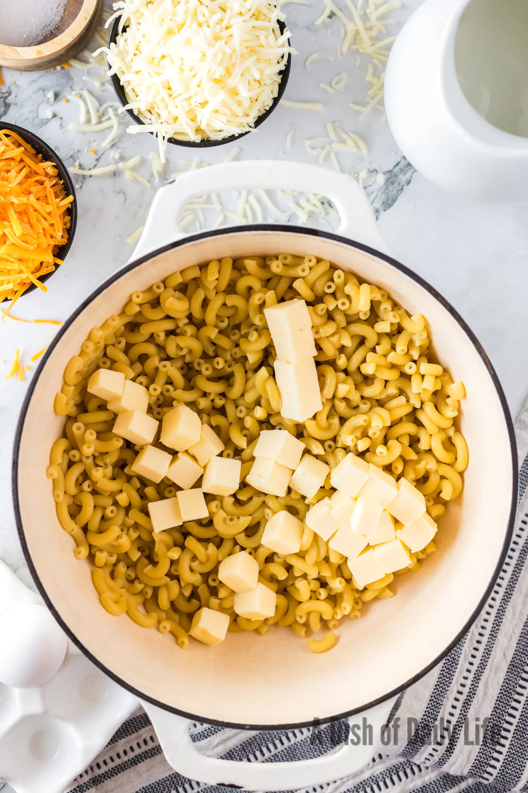 Cooked Macaroni noodles and butter in a pot