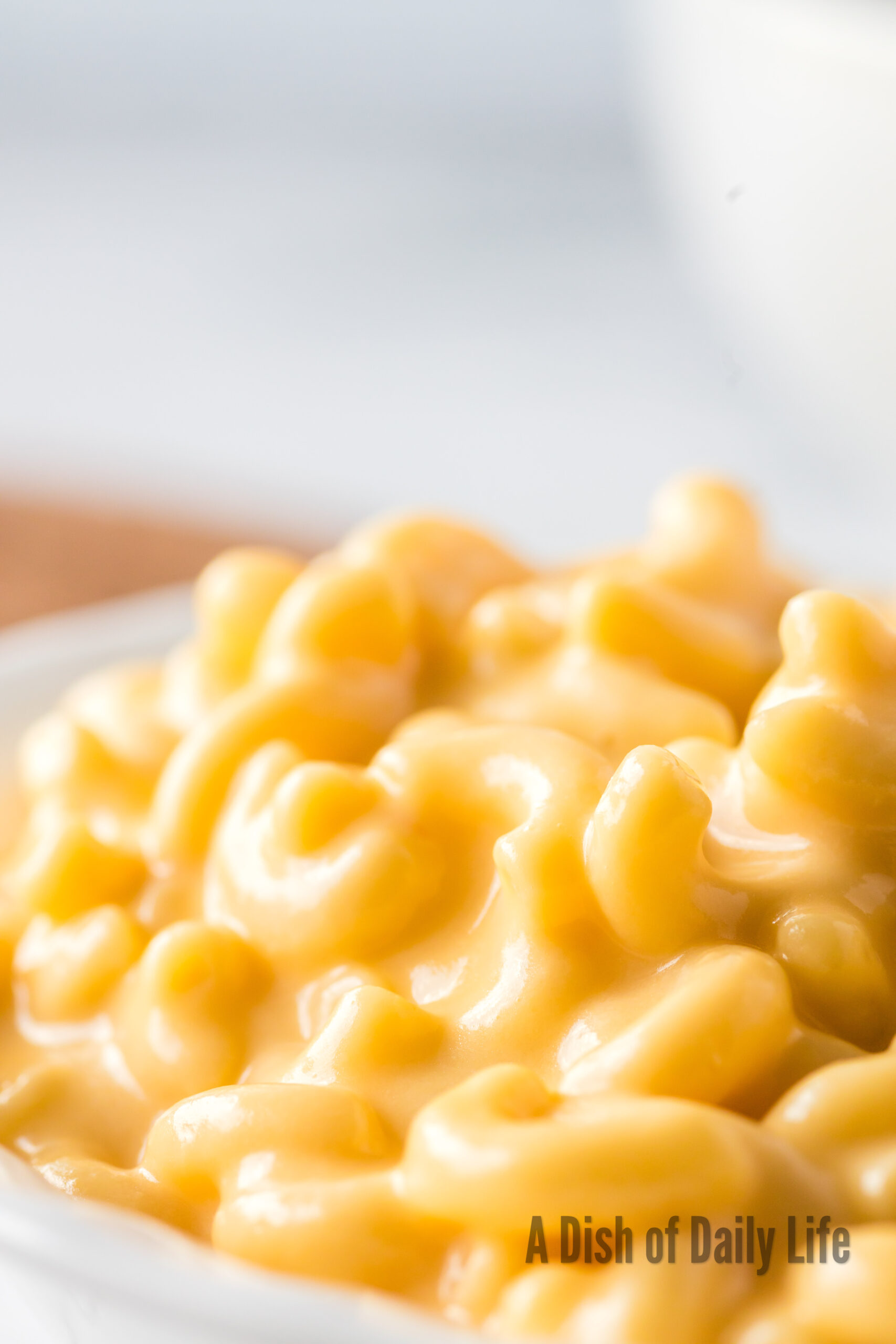 close up of cheesy macaroni in bowl