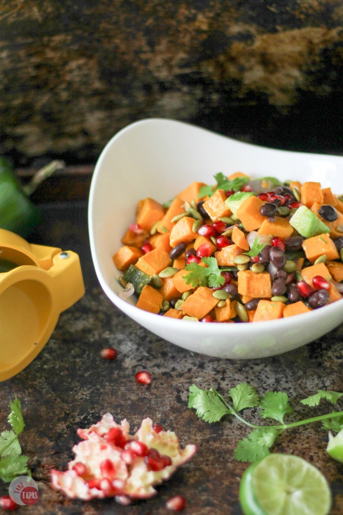This Sweet Potato Salad with a Southwest Vinaigrette is one of our favorites for summer. The combination of sweet potatoes, black beans, crunchy pumpkin seeds, and juicy pomegranate seeds makes a wonderful side dish recipe for potlucks or even dinner. It would make a great vegetarian lunch too!