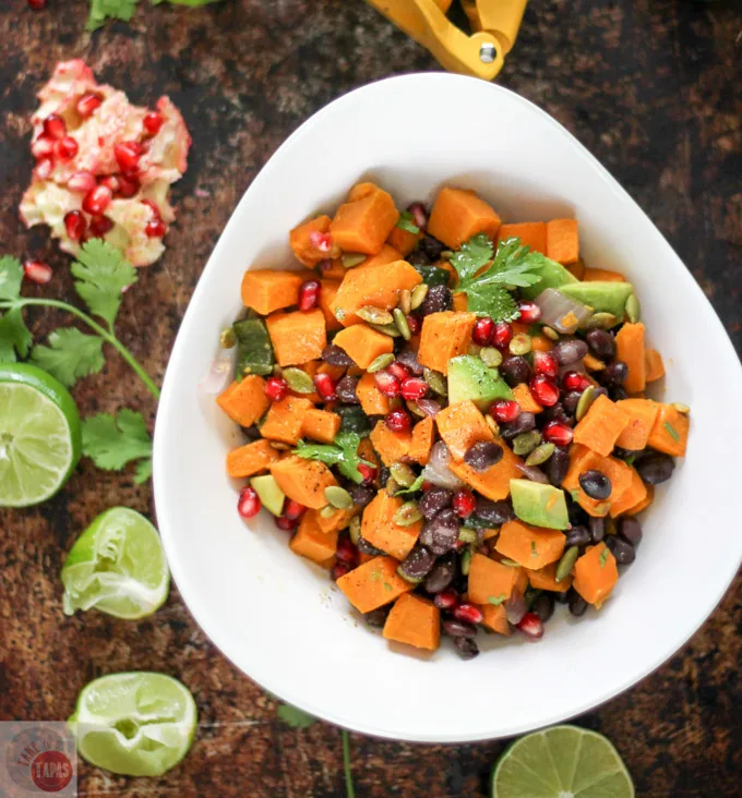 This Sweet Potato Salad with a Southwest Vinaigrette is one of our favorites for summer. The combination of sweet potatoes, black beans, crunchy pumpkin seeds, and juicy pomegranate seeds makes a wonderful side dish recipe for potlucks or even dinner. It would make a great vegetarian lunch too!