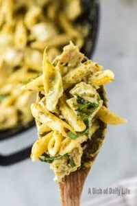 Wooden spoon full of pasta from skillet