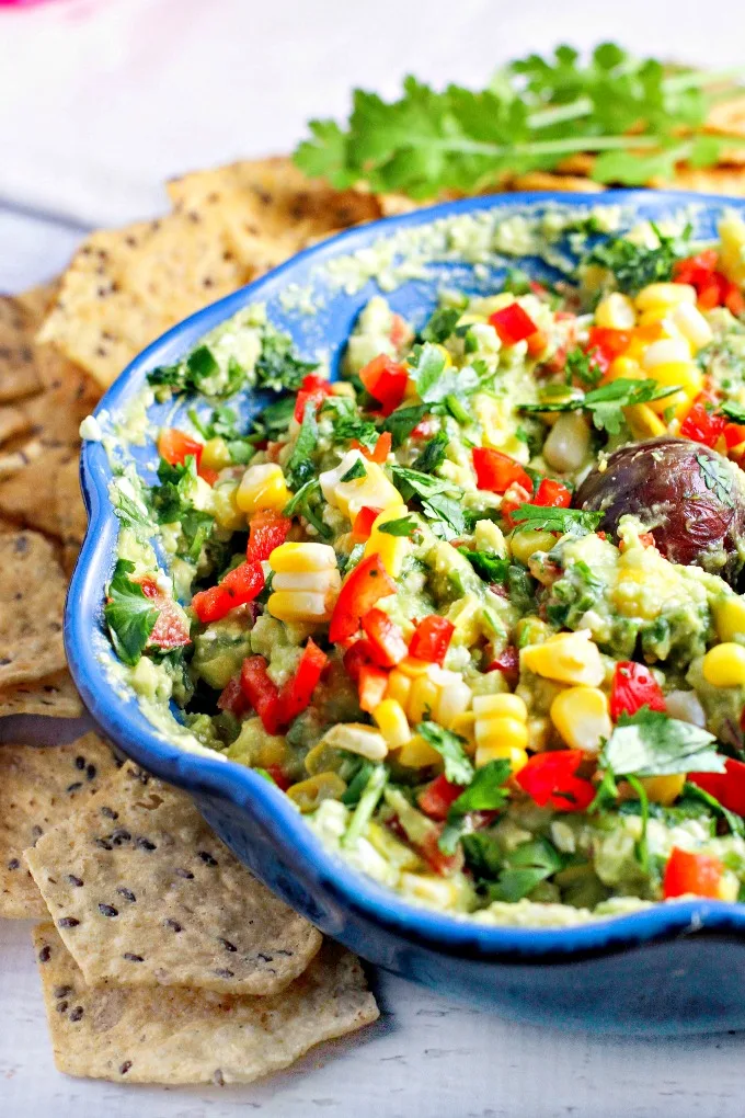 Fiesta Guacamole...a healthy snack packed with vegetables and extra protein for fueling muscle recovery after a tough workout! This easy to make appetizer recipe is perfect for parties and Mexican night as well!