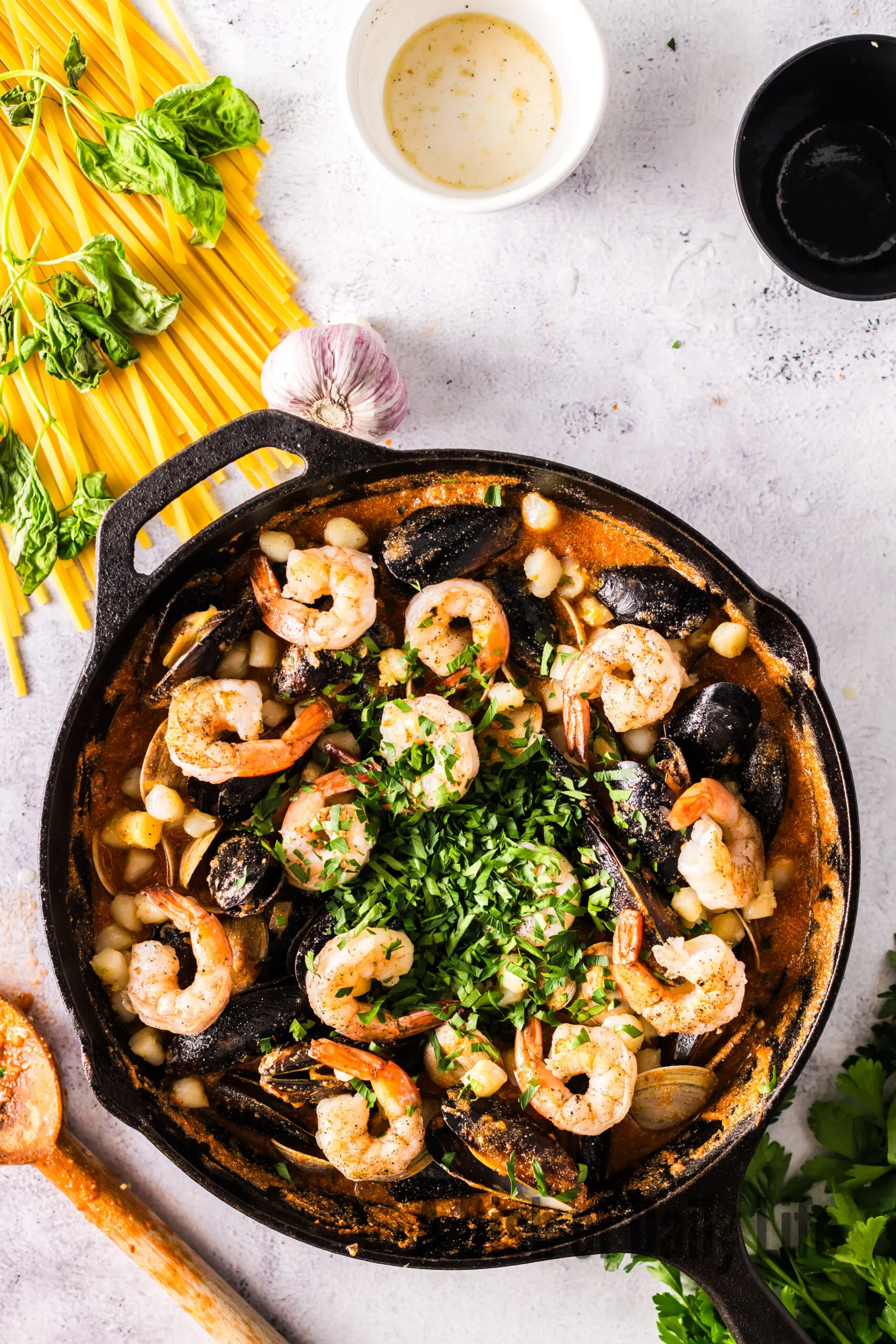 parsley added to seafood pasta