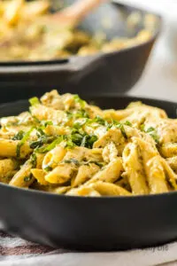 side view of artichoke pasta in skillet, cooked and ready to eat