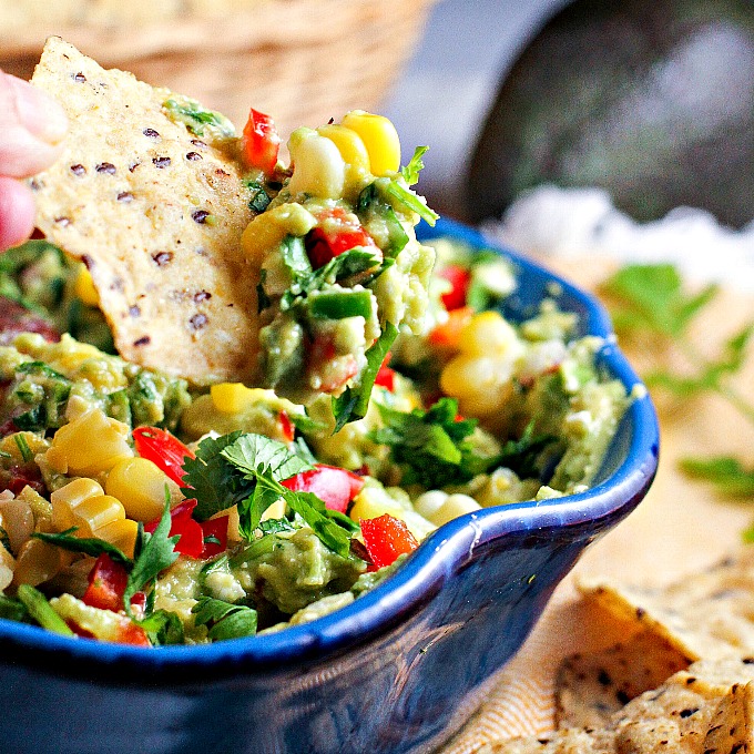 Fiesta Guacamole...a healthy snack packed with vegetables and extra protein for fueling muscle recovery after a tough workout! This easy to make appetizer recipe is perfect for parties and Mexican night as well!