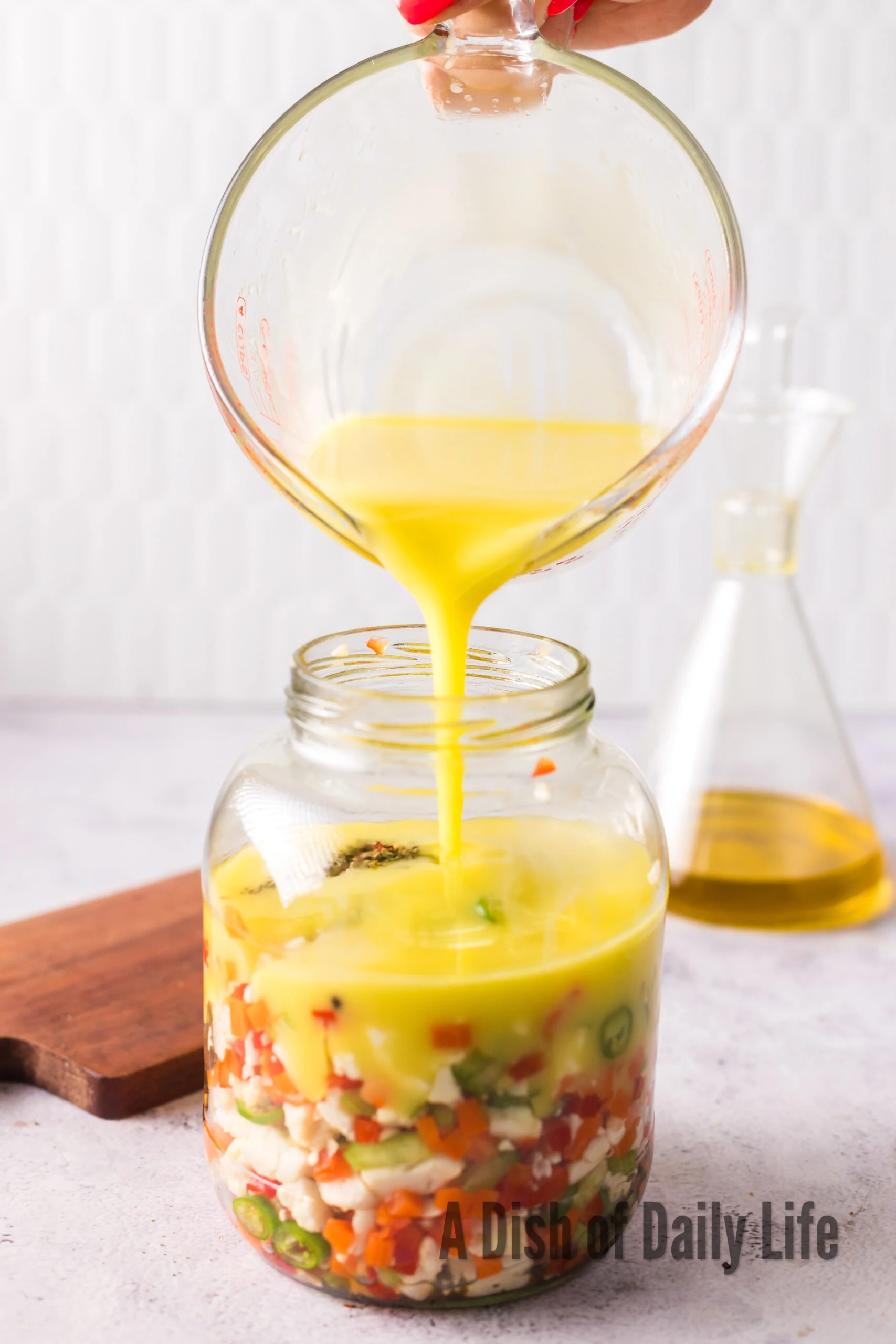 oil and vinegar whisked in a bowl and poured over vegetables.