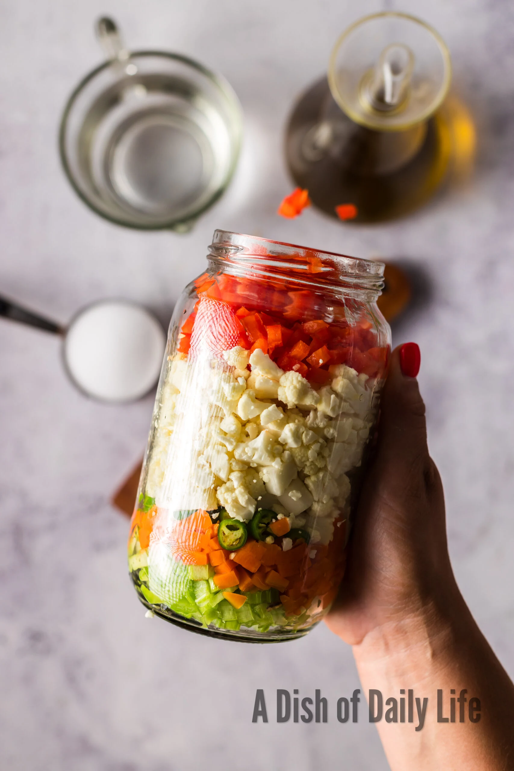 Vegetables layered in a jar.