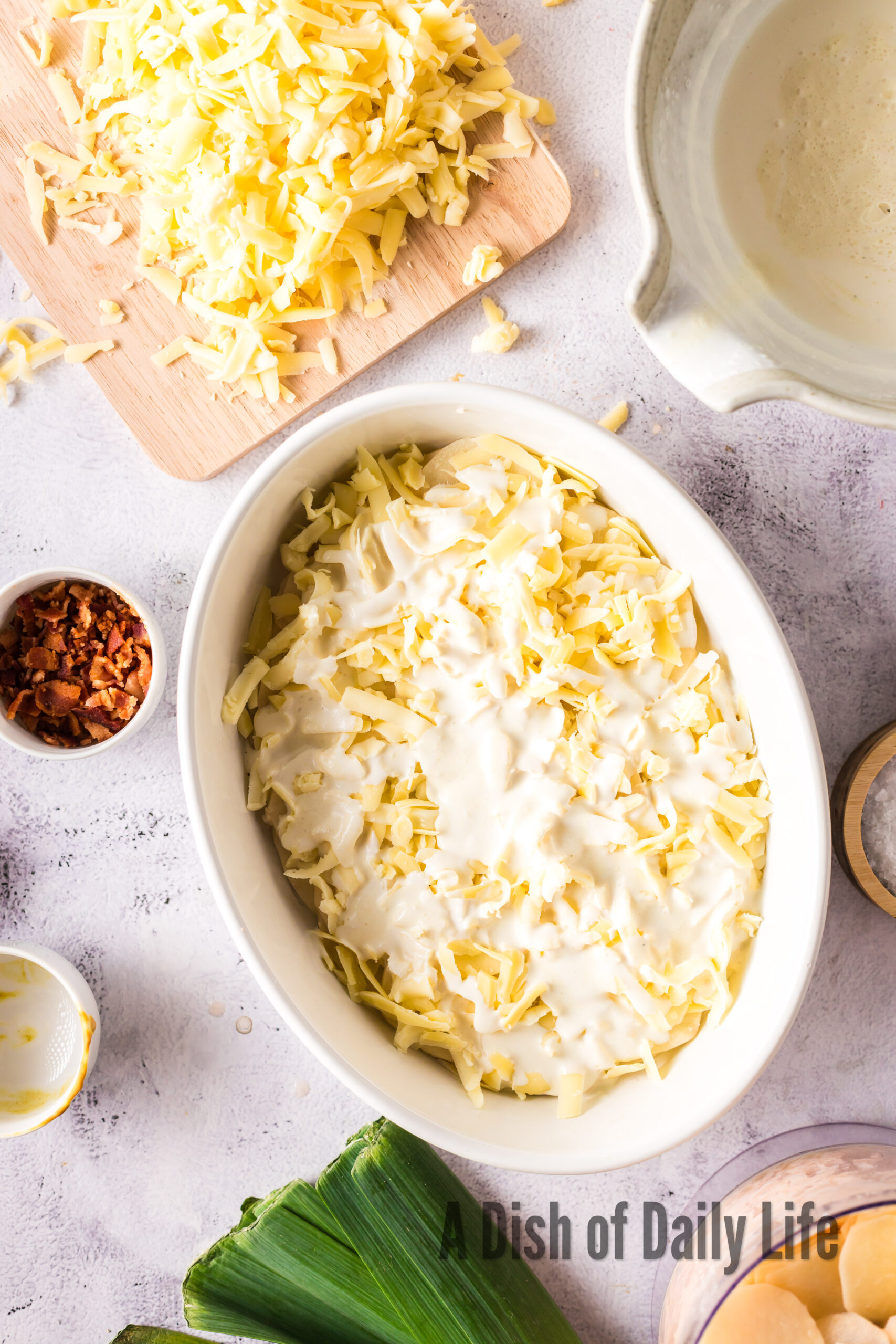 Potatoes and cheese with cream poured over the top.