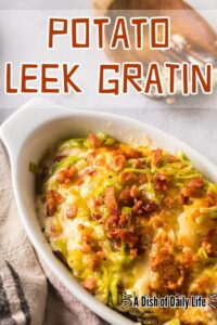 Main image for Potato Leek Gratin Recipe. A portion scooped into a bowl.