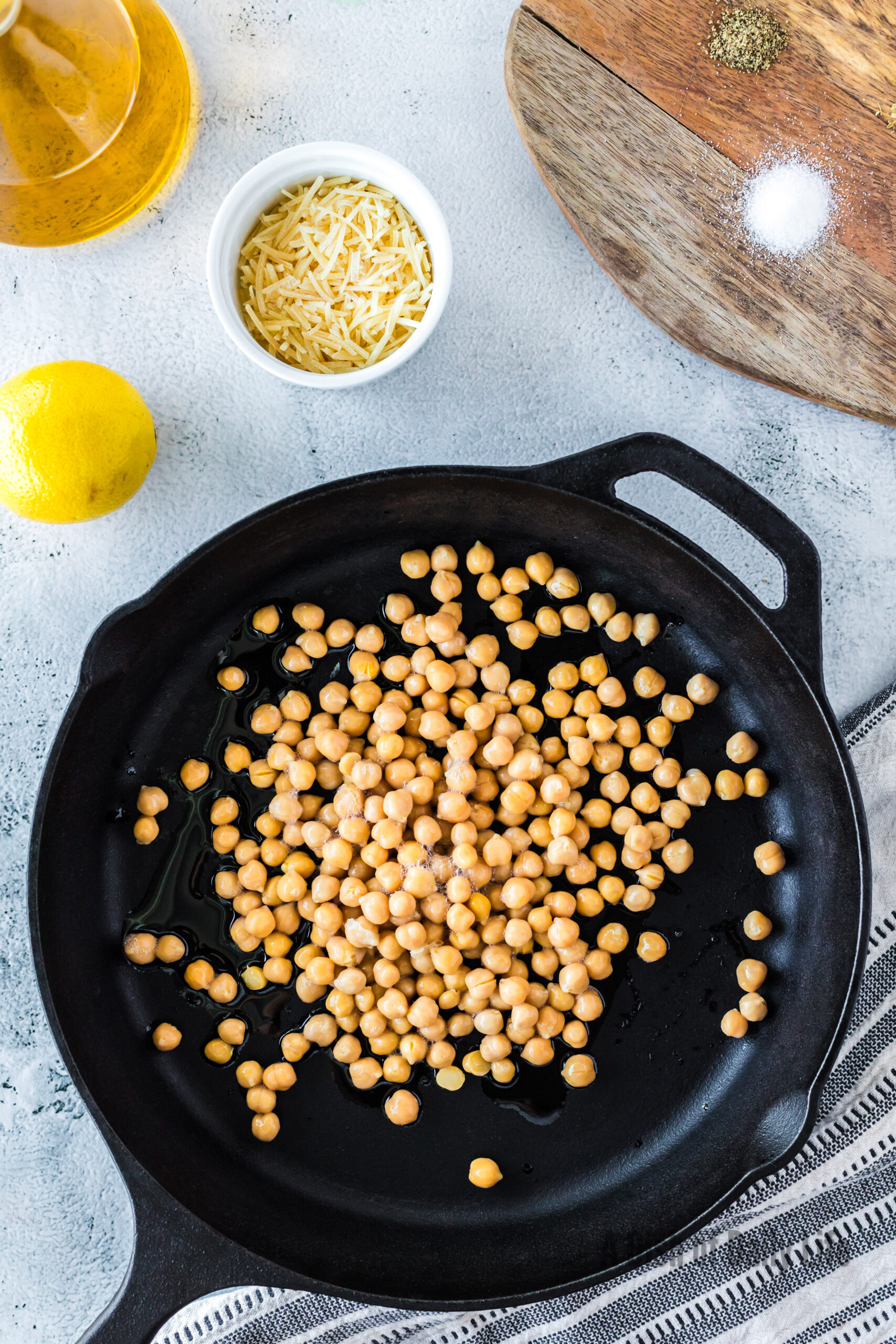 drained chickpeas dried on paper towels. Chickpeas in a skillet with oil.