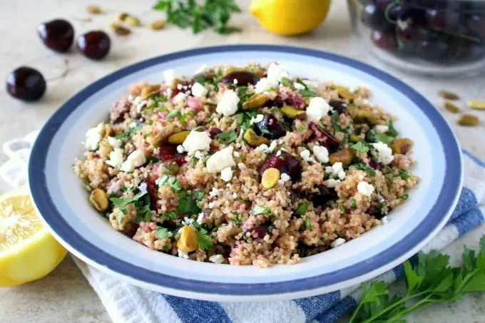 You're going to love this new twist on tabbouleh! This easy Cherry Couscous Tabbouleh makes a delicious and healthy side dish recipe, and it's easily customized, if you'd like to make it vegan, gluten-free or even turn it into a main dish. The cherries complement the herb and lemon juice combination nicely, and pistachios add the perfect crunch! 