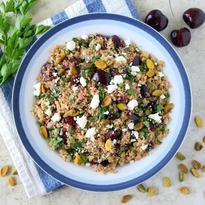 You're going to love this new twist on tabbouleh! This easy Cherry Couscous Tabbouleh makes a delicious and healthy side dish recipe, and it's easily customized, if you'd like to make it vegan, gluten-free or even turn it into a main dish. The cherries complement the herb and lemon juice combination nicely, and pistachios add the perfect crunch!