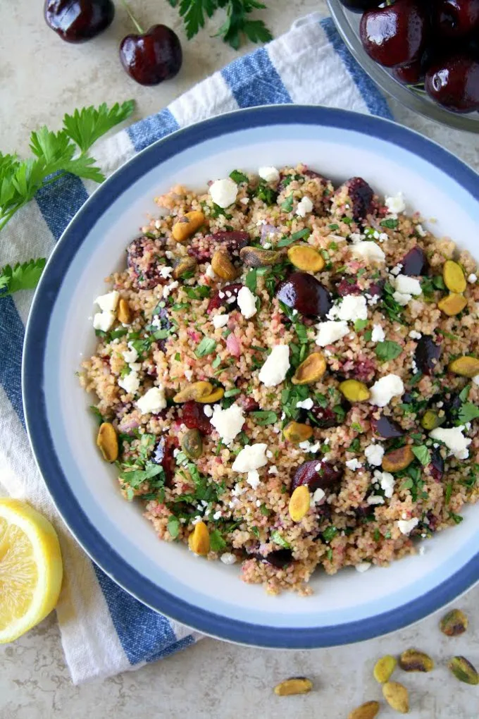 You're going to love this new twist on tabbouleh! This easy Cherry Couscous Tabbouleh makes a delicious and healthy side dish recipe, and it's easily customized, if you'd like to make it vegan, gluten-free or even turn it into a main dish. The cherries complement the herb and lemon juice combination nicely, and pistachios add the perfect crunch!