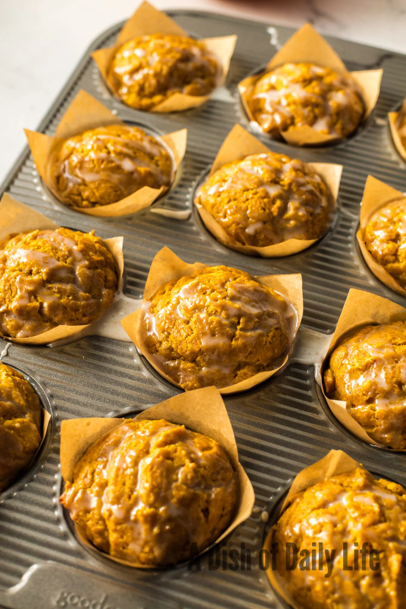 glazed muffins in muffin tin.