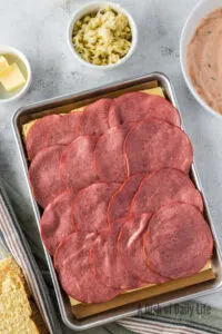 Corned beef slices laid on top of swiss cheese