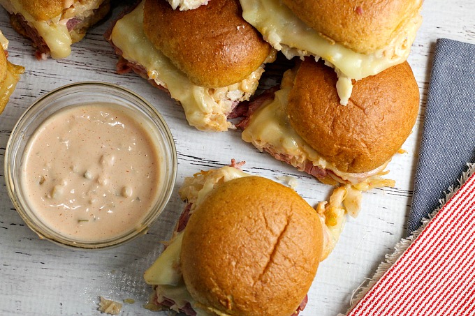 Get ready for game day with these Reuben Sliders with Homemade Russian Dressing...they're an easy to make appetizer recipe that everyone will love!
