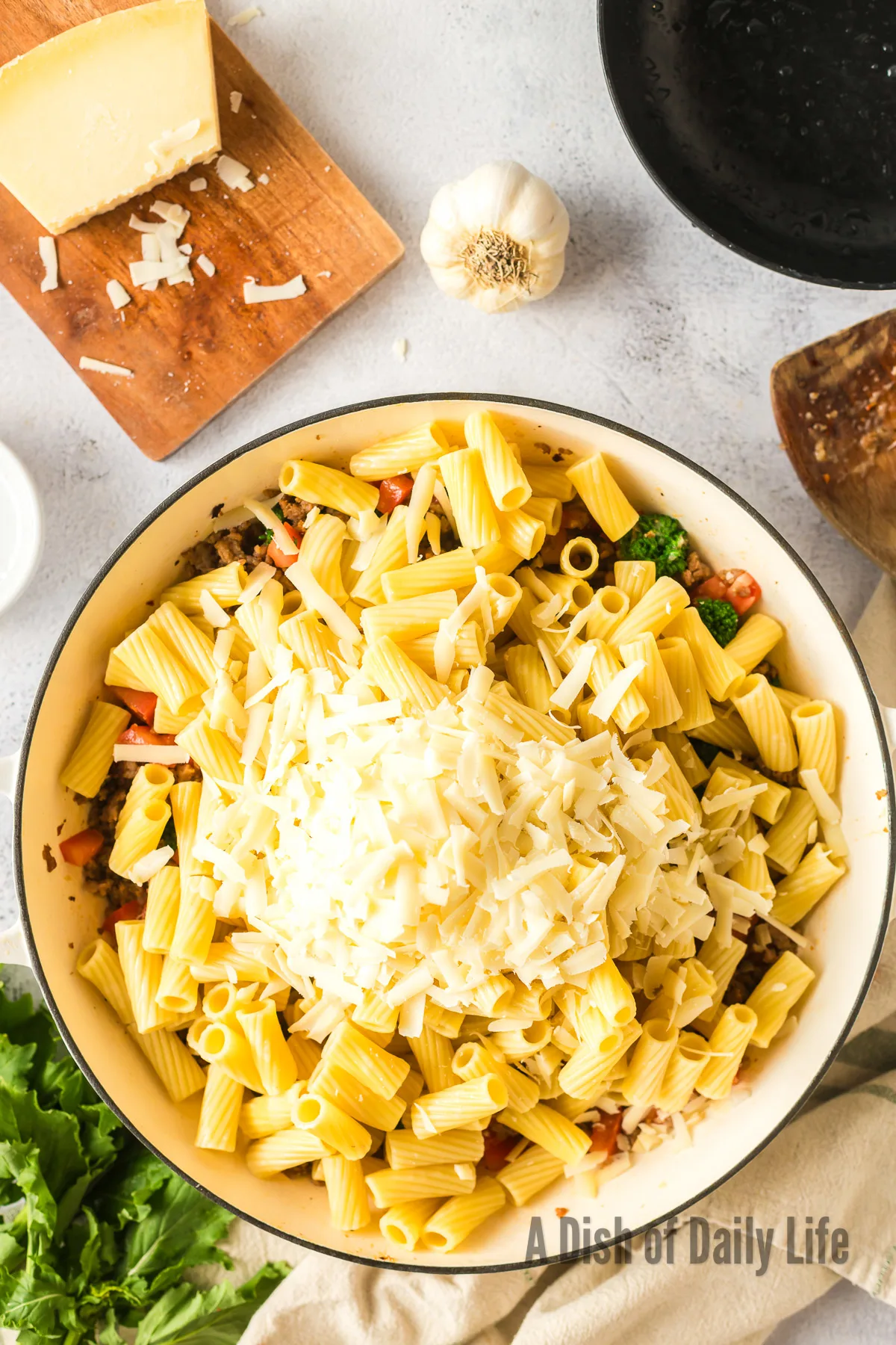 cooked pasta added to sausage mixture in skillet