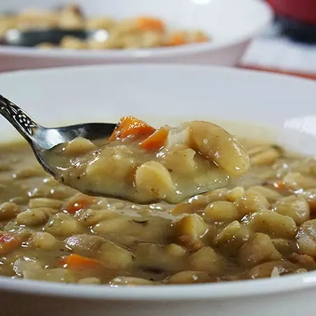 Love bean soup but don't have a day to make it? No problem! This delicious Bean with Bacon Soup recipe has all the slow cooked flavor you love, but can be made quickly using pantry ingredients for an easy comfort food weeknight meal the whole family will love!