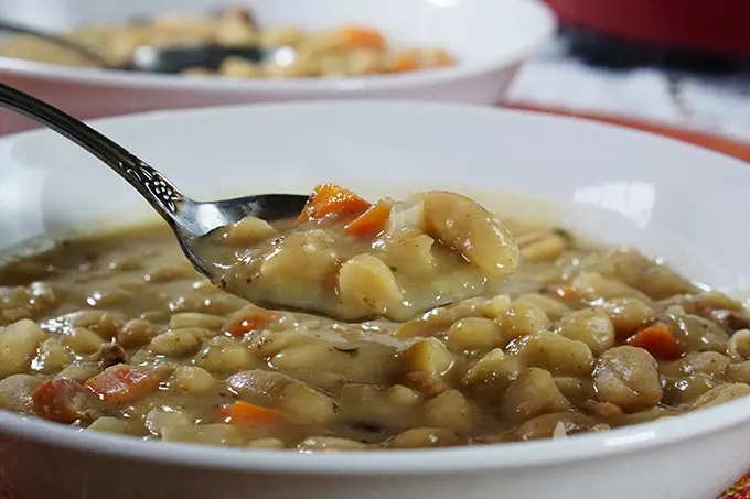 Love bean soup but don't have a day to make it? No problem! This delicious Bean Soup with Bacon recipe has all the slow cooked flavor you love, but can be made quickly using pantry ingredients for an easy comfort food weeknight meal the whole family will love!